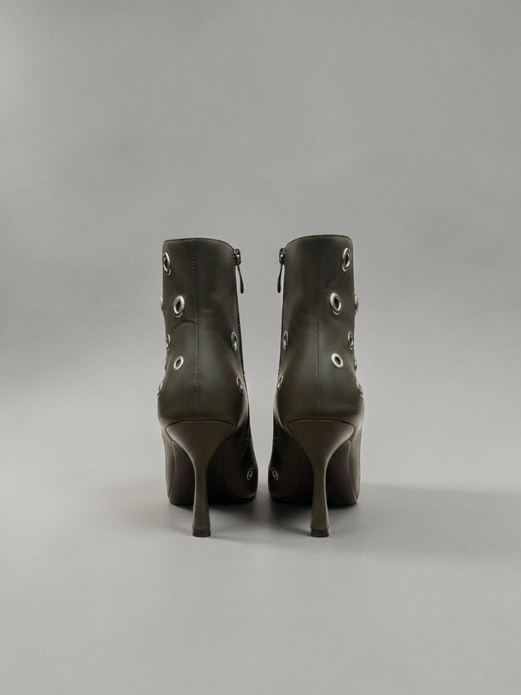 Day One Concept Store black leather ankle boots with silver eyelet details and pointed toe.