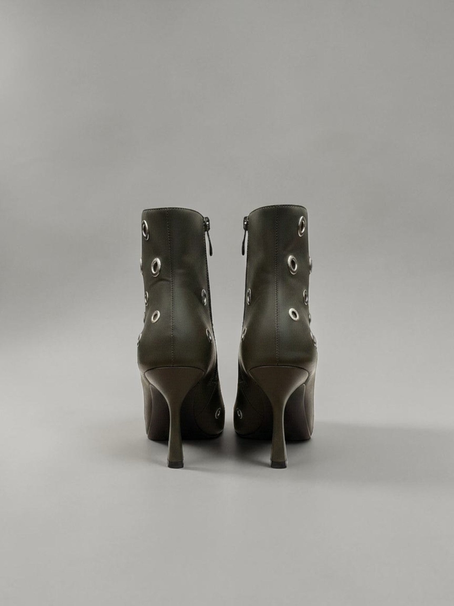 Day One Concept Store black leather ankle boots with silver eyelet details and pointed toe.
