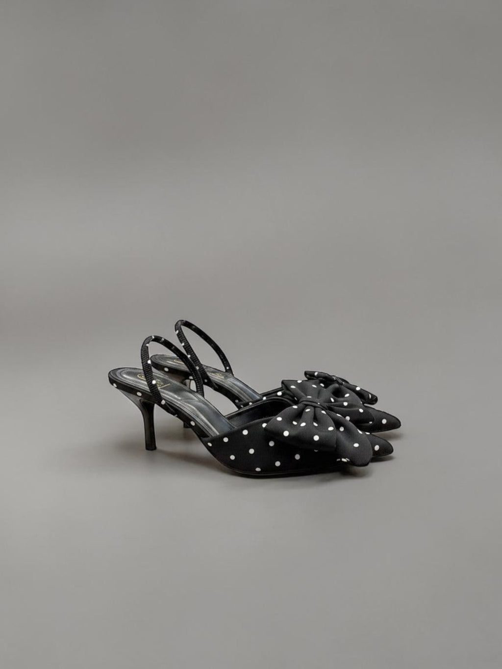 Day One Concept Store black slingback heels with white polka dots and a large bow detail on the toe.