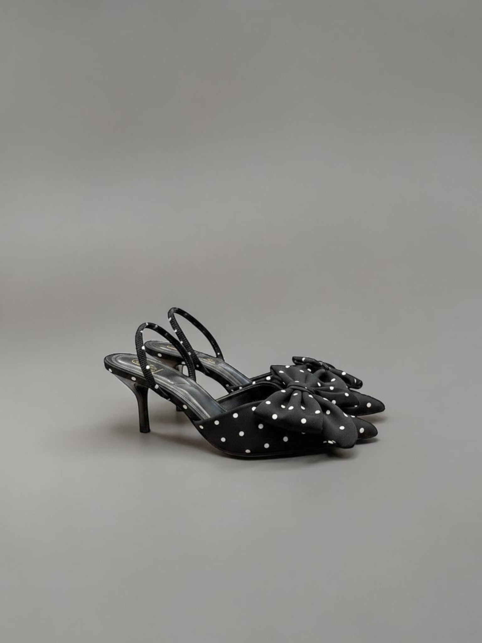 Day One Concept Store black slingback heels with white polka dots and a large bow detail on the toe.