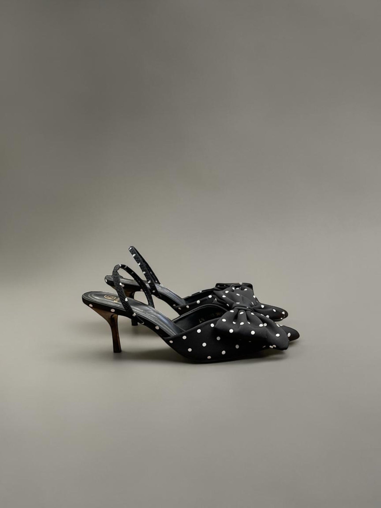 Day One Concept Store black polka dot slingback heels with a large bow detail and thin stiletto heel.