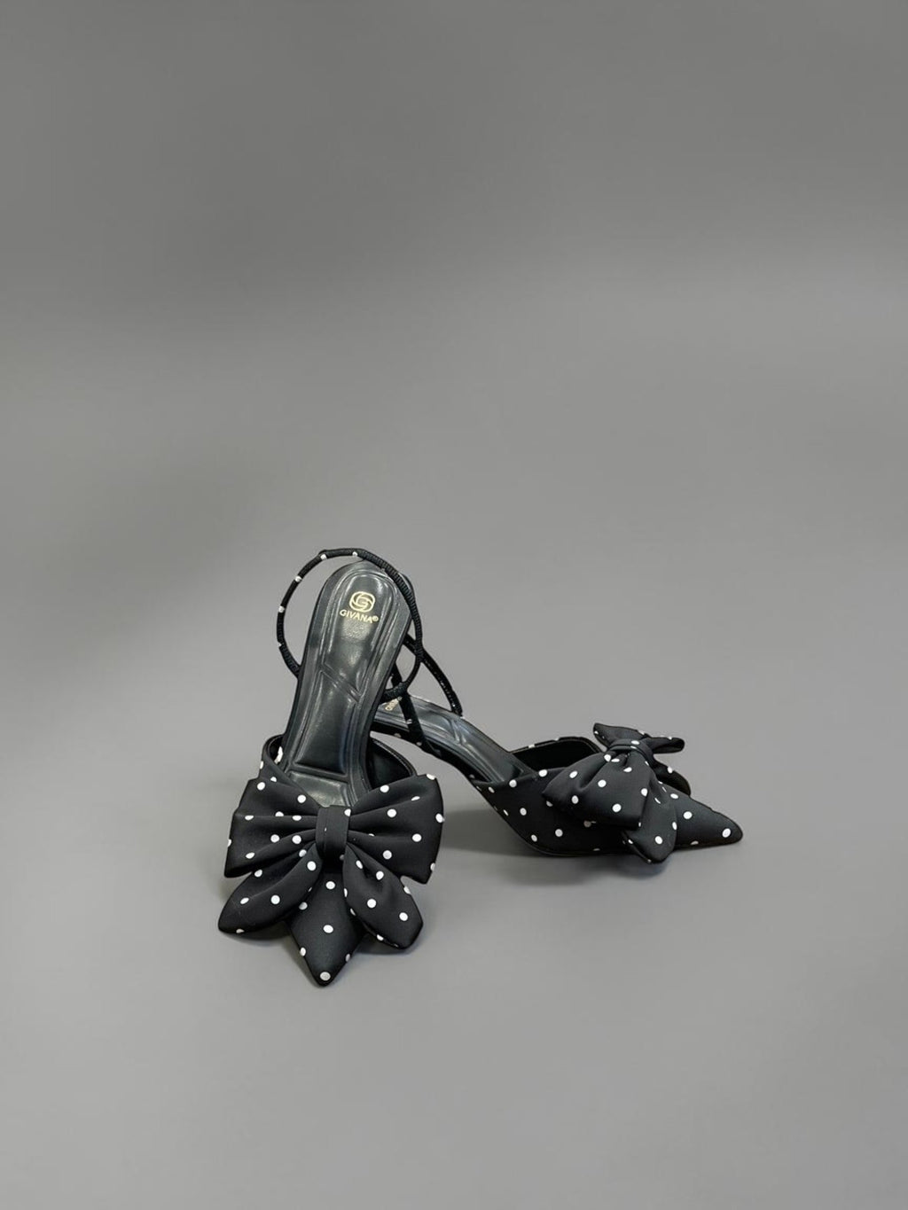 Day One Concept Store black polka dot slingback heels with large bow detail and stiletto heel.