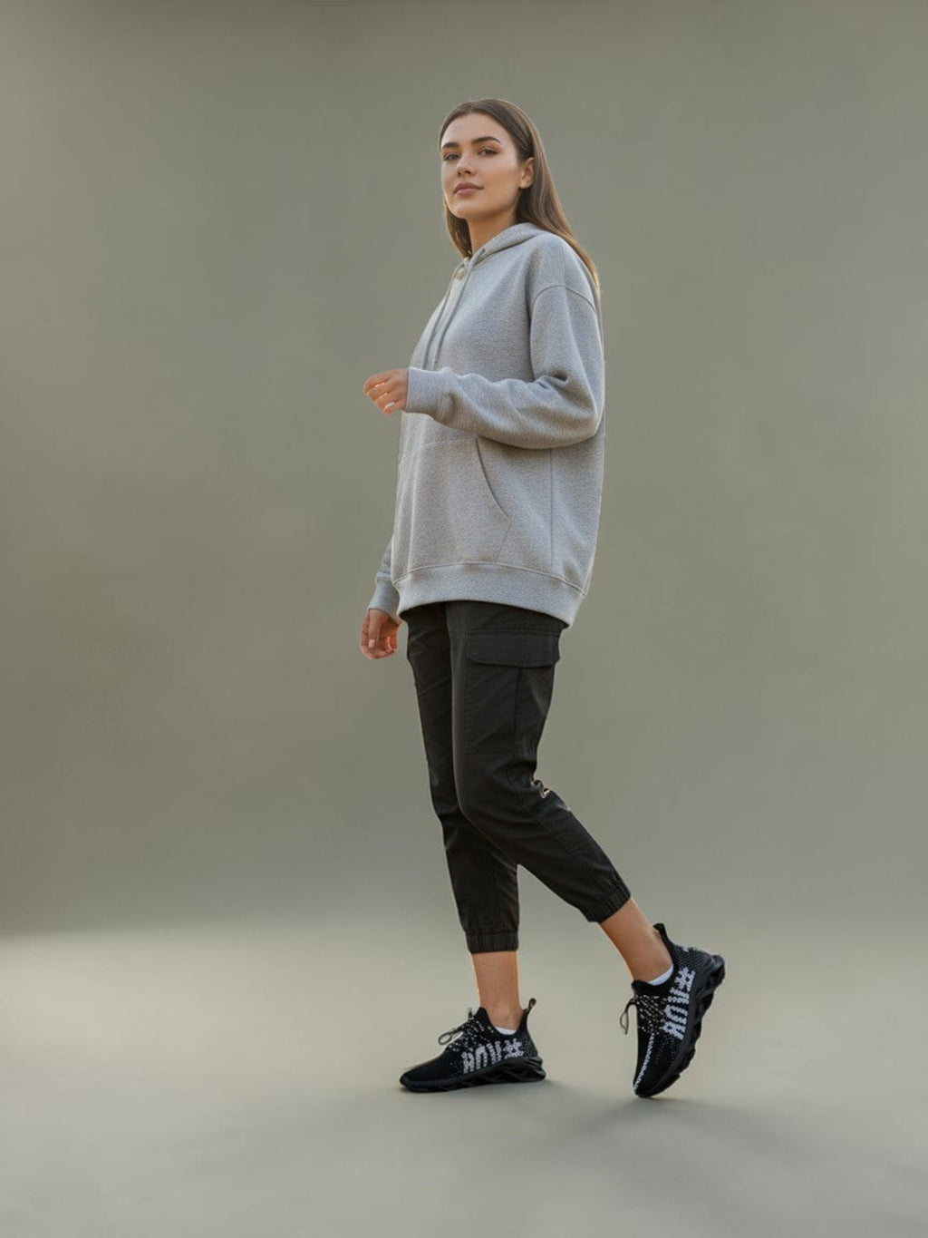 Day One Concept Store black and white knit sneakers with chunky sole, worn by a woman in a park.