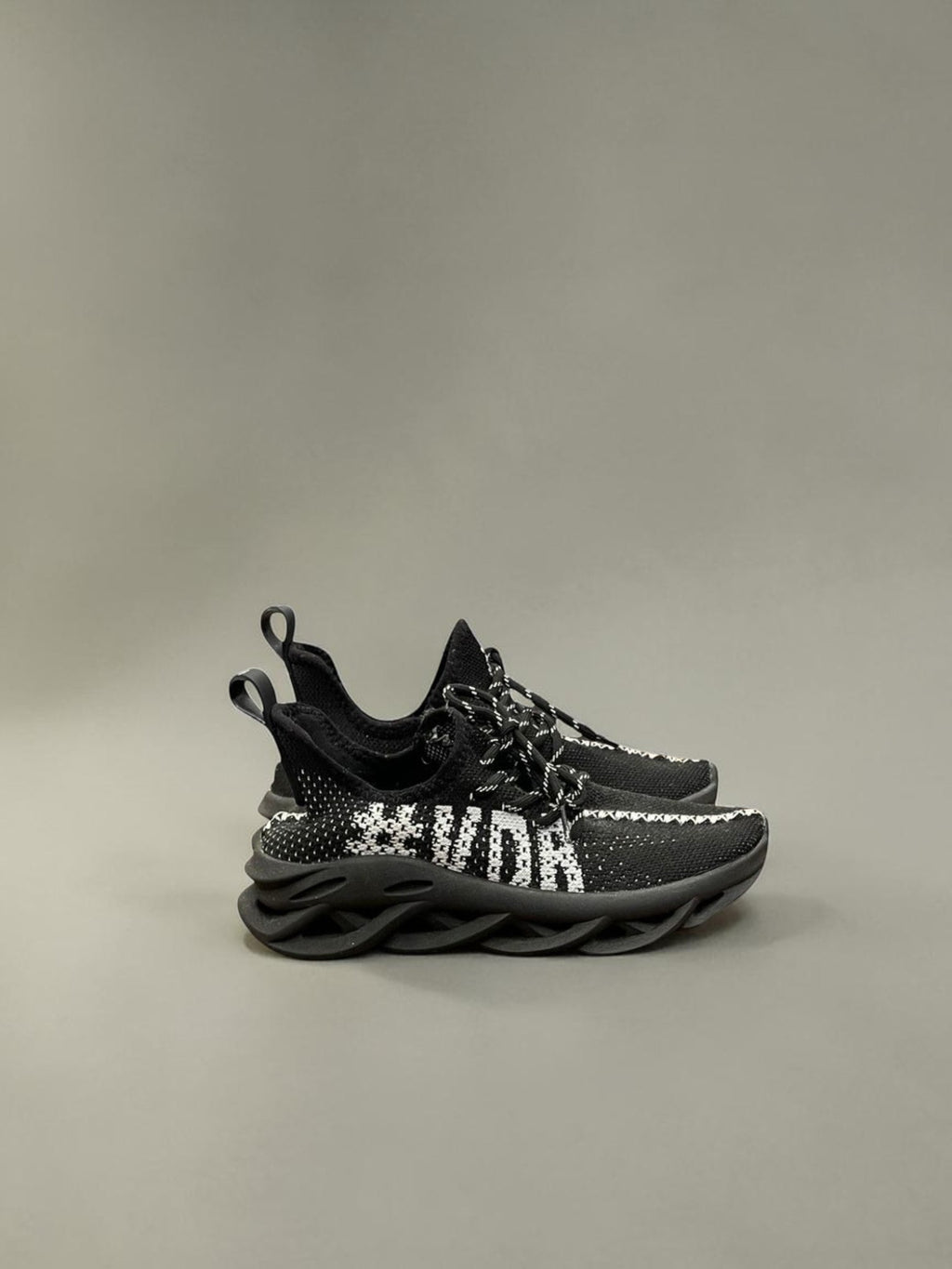 Day One Concept Store black and white knit sneakers with chunky sole and graphic detail.