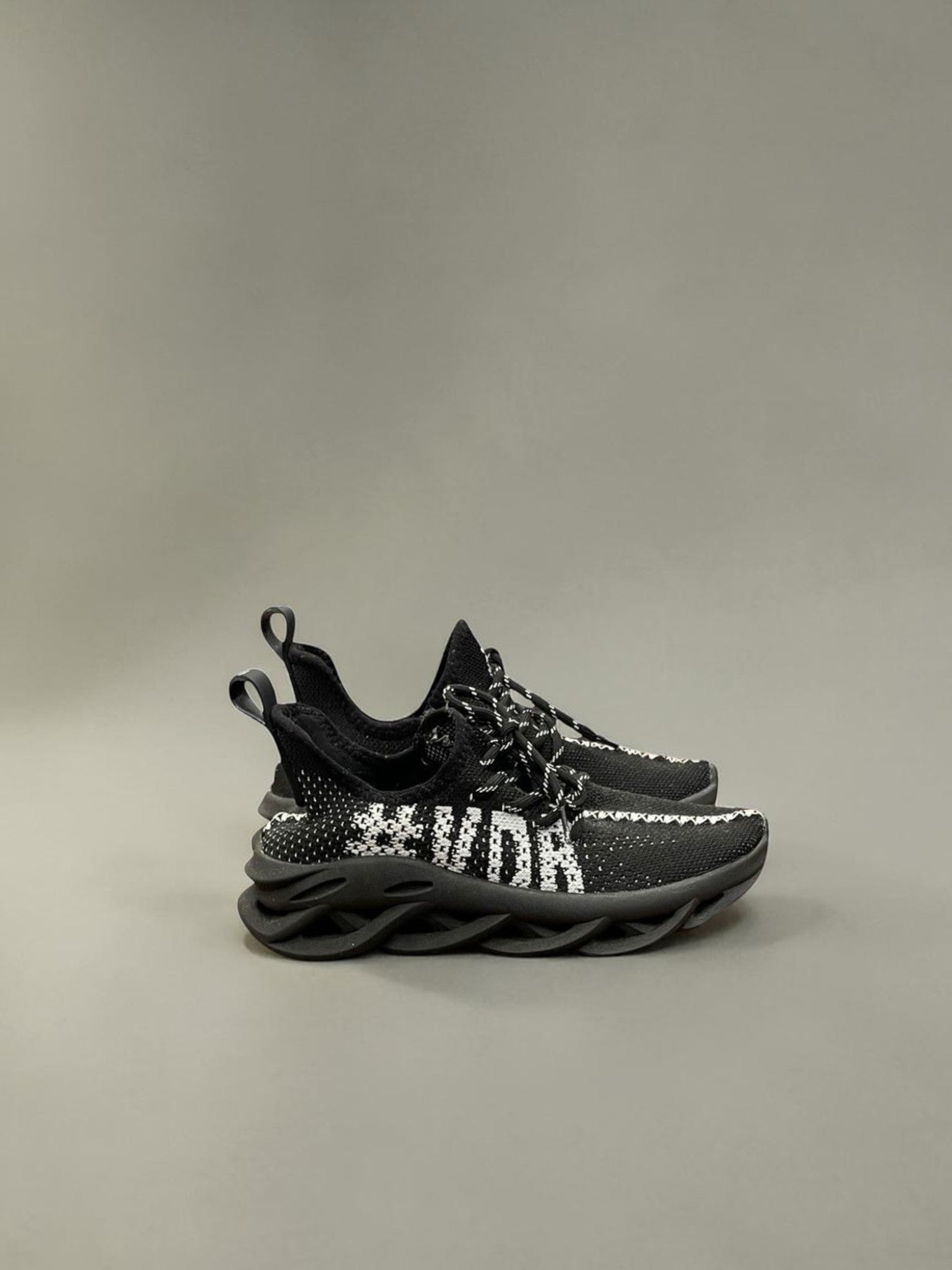 Day One Concept Store black and white knit sneakers with chunky sole and graphic detail.