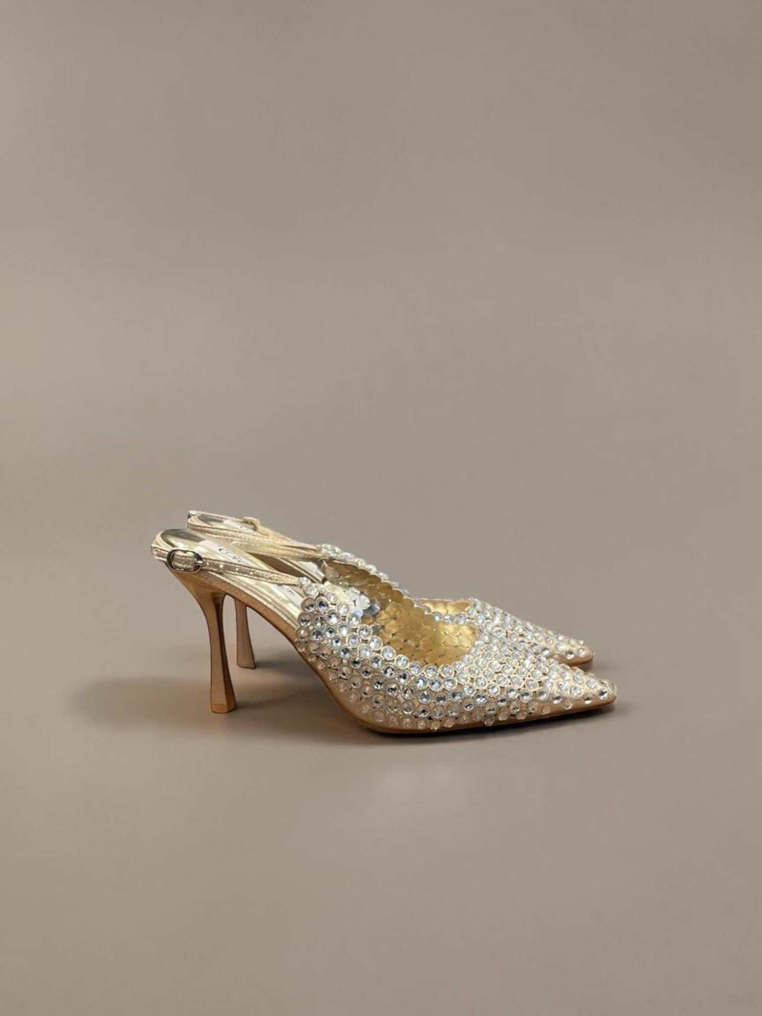 Day One Concept Store silver slingback heels covered in rhinestones with a pointed toe and stiletto heel.