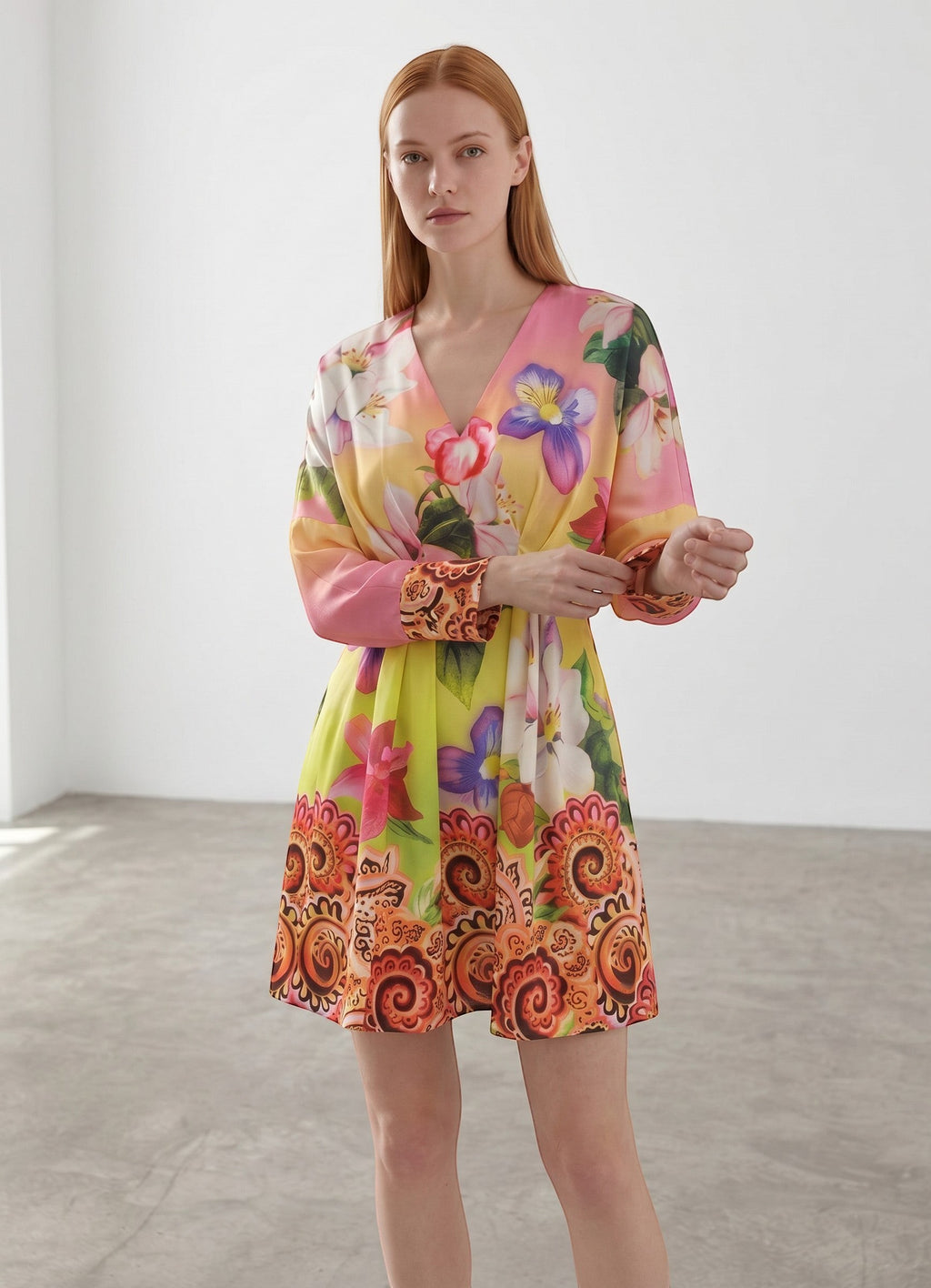 Day One Concept Store yellow floral print mini dress with V-neck, cinched waist, and paisley border. Model is wearing a size S.