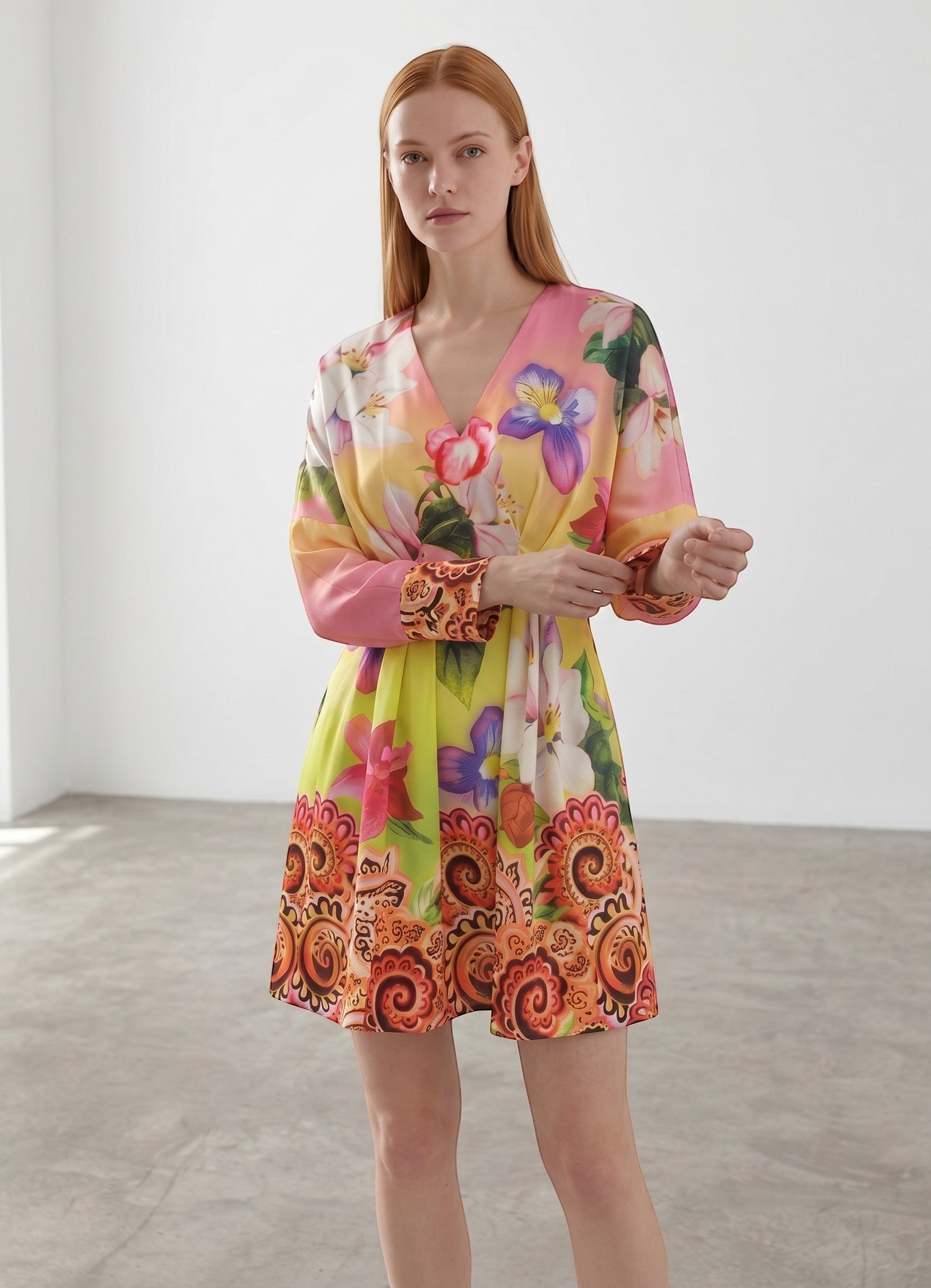 Day One Concept Store yellow floral print mini dress with V-neck, cinched waist, and paisley border. Model is wearing a size S.