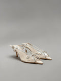 Day One Concept Store beige slingback sandals with clear straps and jeweled bow detail. Kitten heel.