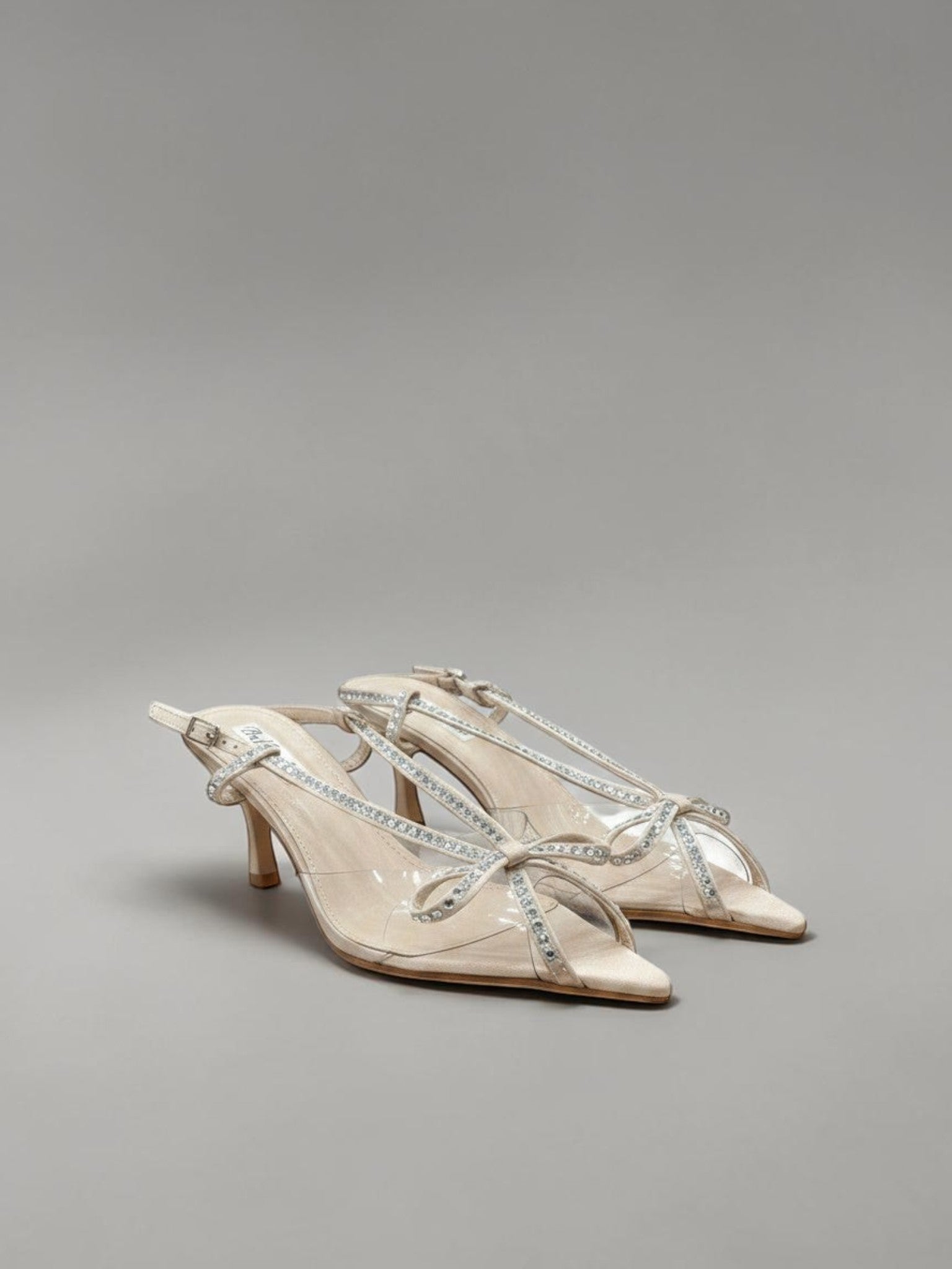 Day One Concept Store beige slingback sandals with clear straps and jeweled bow detail. Kitten heel.