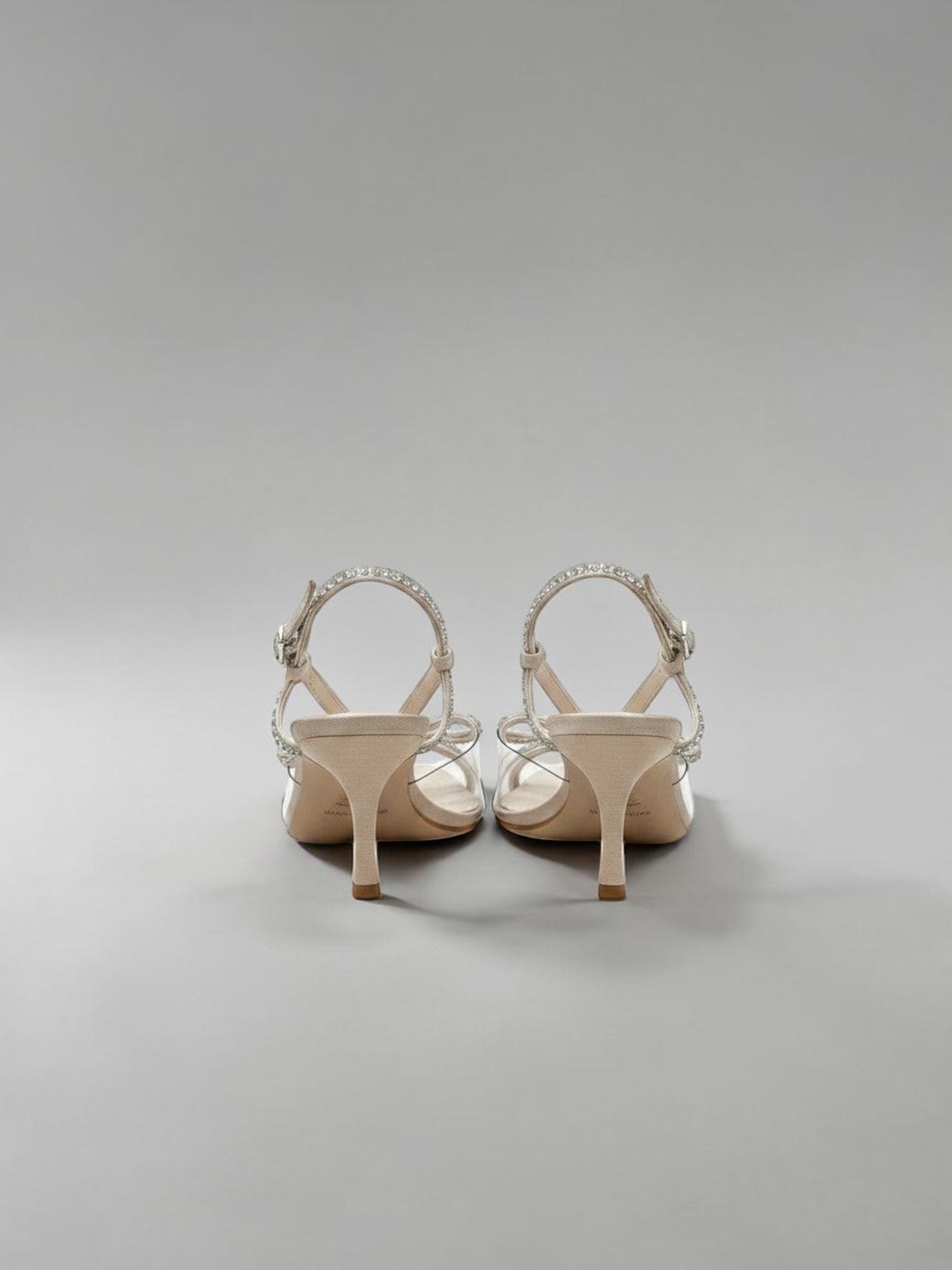 Day One Concept Store beige slingback sandals with clear straps and crystal embellishments on a stiletto heel.