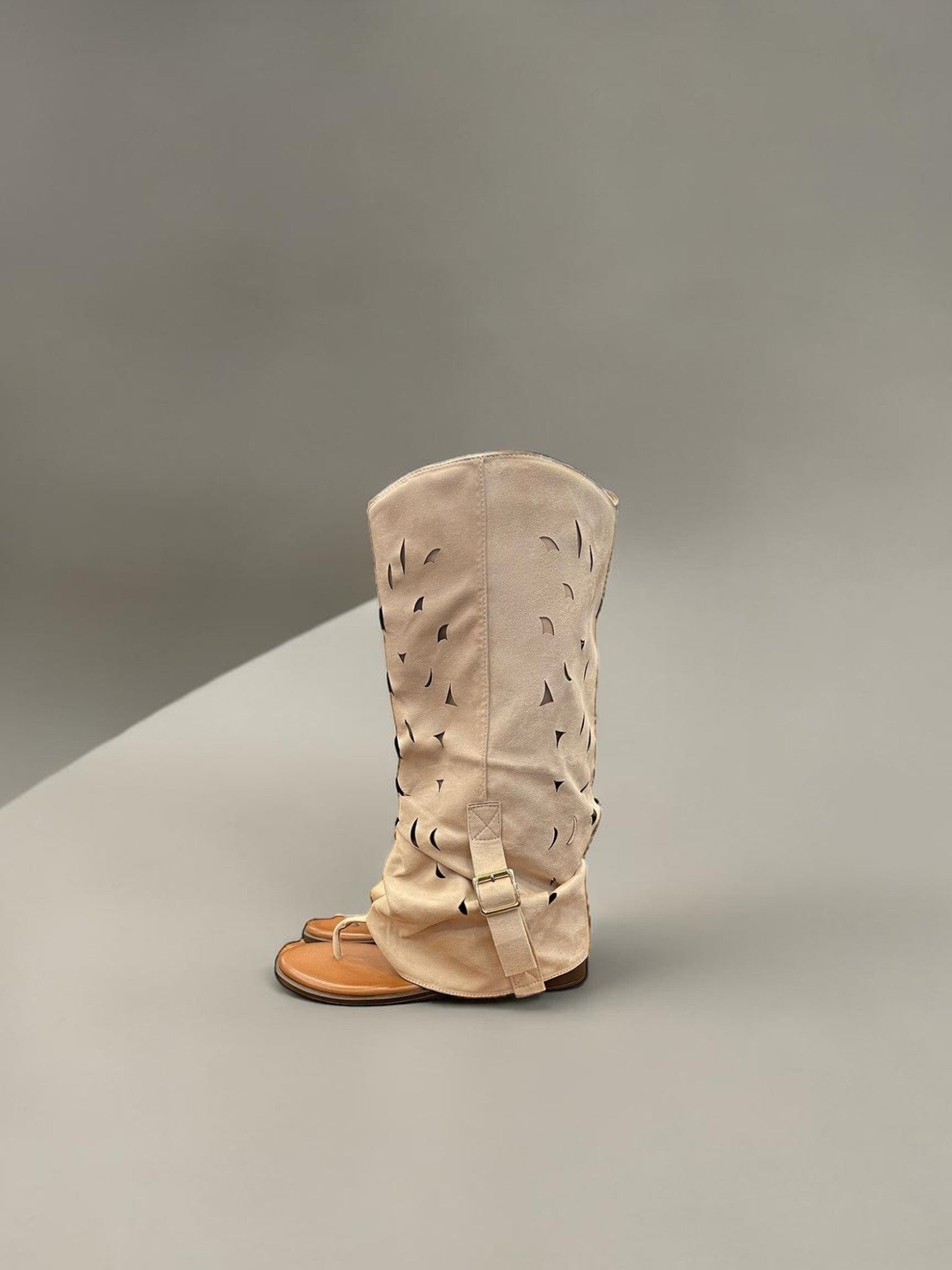 Day One Concept Store beige suede tall boots with cut-out details and buckle strap.