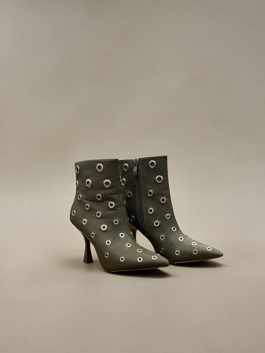Day One Concept Store black leather ankle boots with pointed toe, stiletto heel, and silver eyelet details.