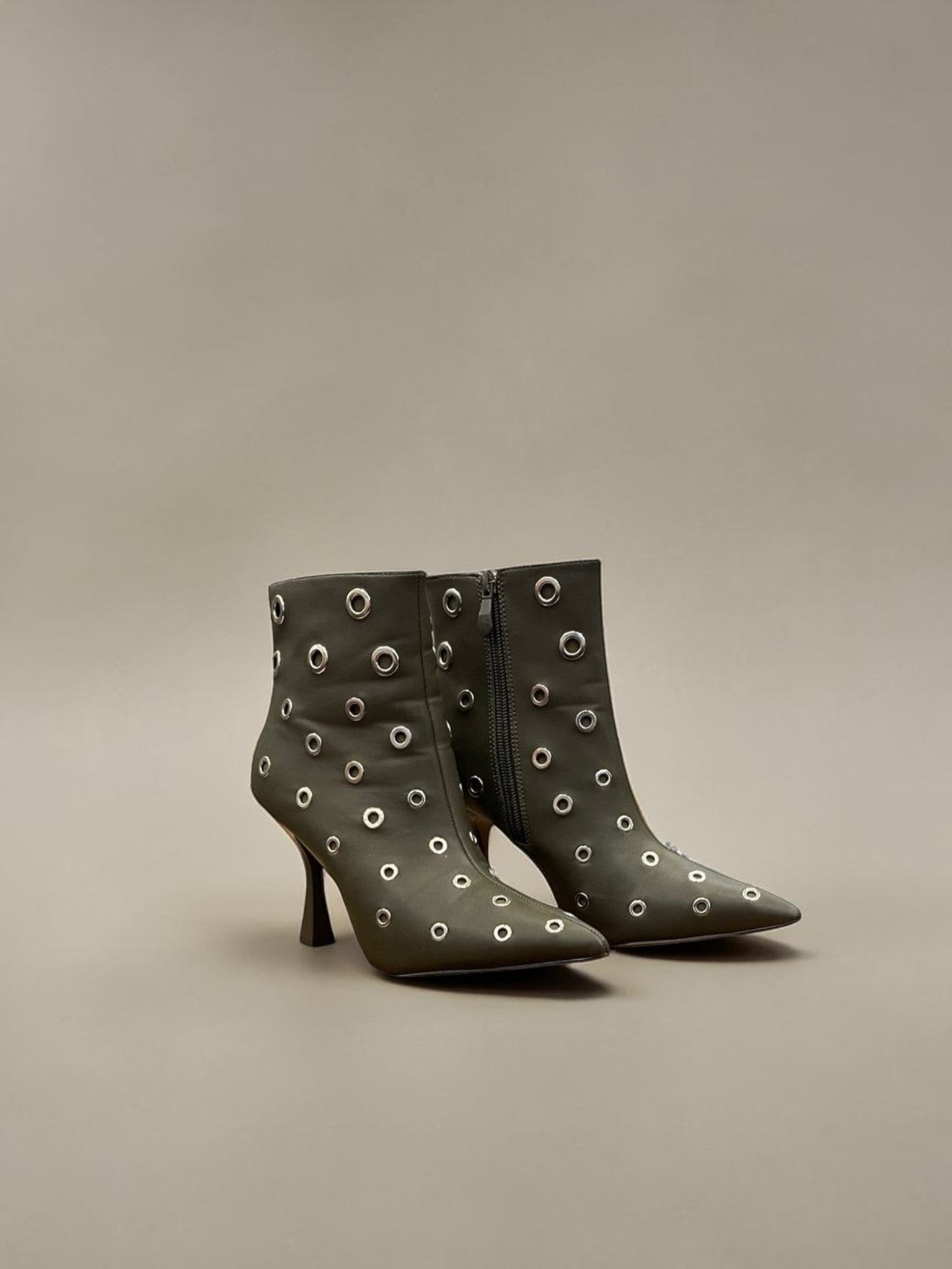Day One Concept Store black leather ankle boots with pointed toe, stiletto heel, and silver eyelet details.