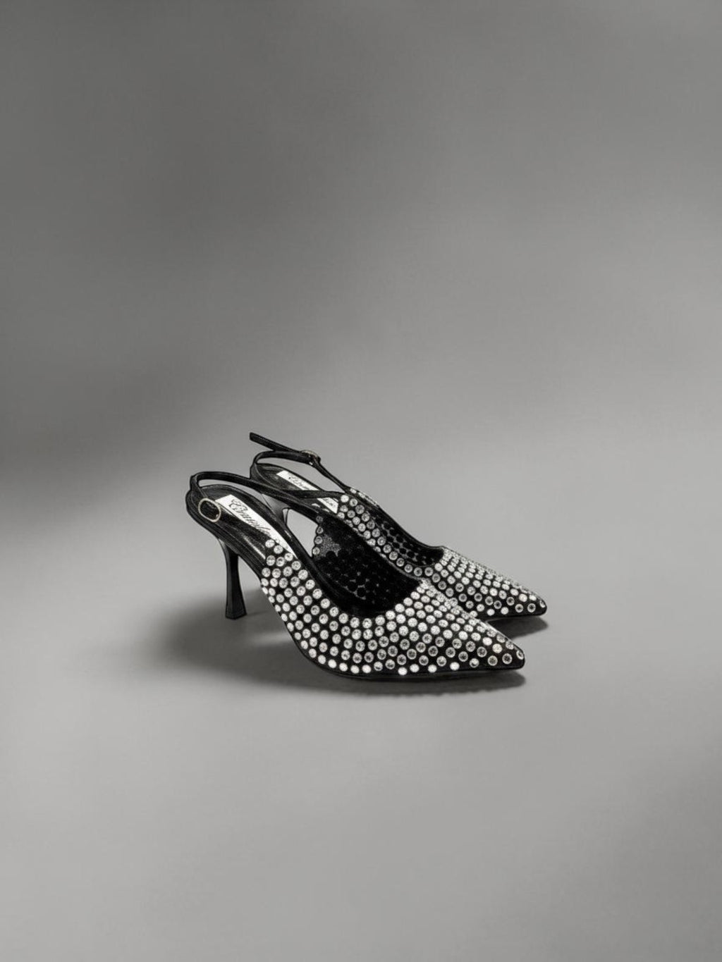 Day One Concept Store black slingback heels with pointed toe and rhinestone embellishments, adjustable ankle strap.