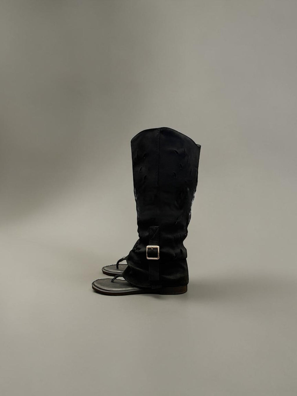 Day One Concept Store black suede gladiator sandals with buckle detail and thong toe.