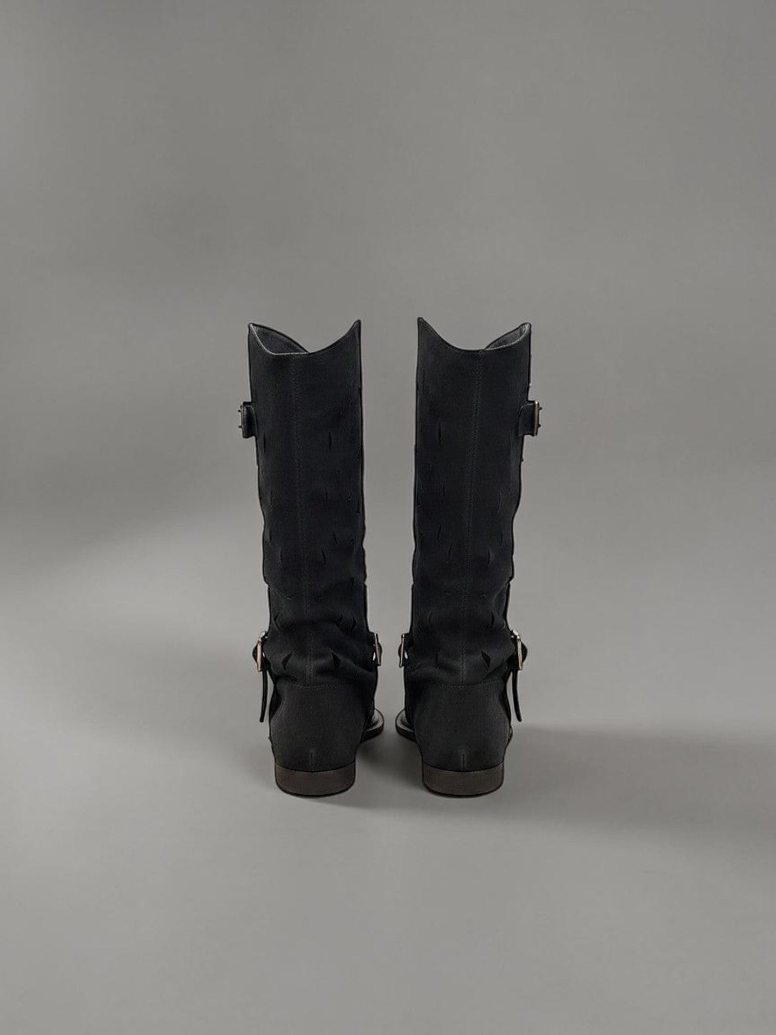Day One Concept Store black suede tall boots with buckle detail and cut-out pattern.