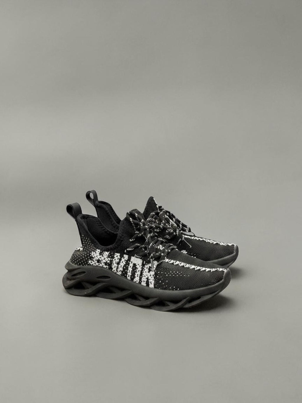 Day One Concept Store black and white knit sneakers with chunky sole and graphic detail.