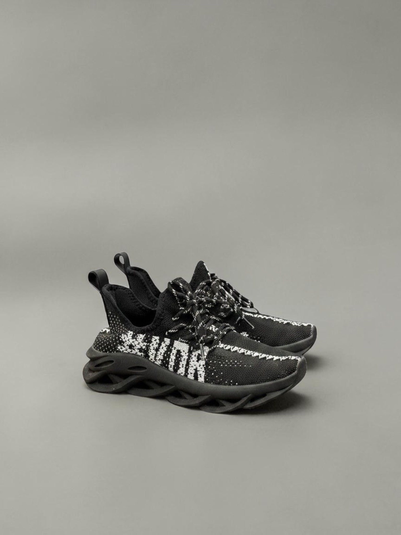 Day One Concept Store black and white knit sneakers with chunky sole and graphic detail.