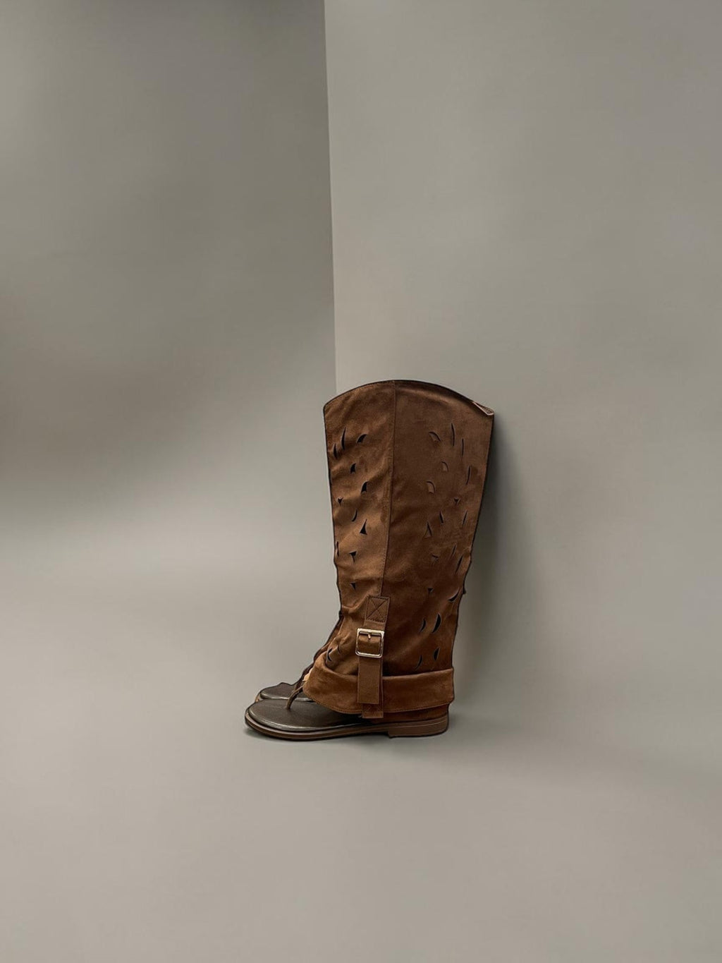 Day One Concept Store brown perforated leather tall boots with ankle strap and buckle detail.