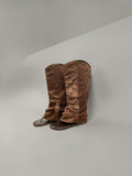 Day One Concept Store brown perforated leather tall boots with buckle detail and flat sole.