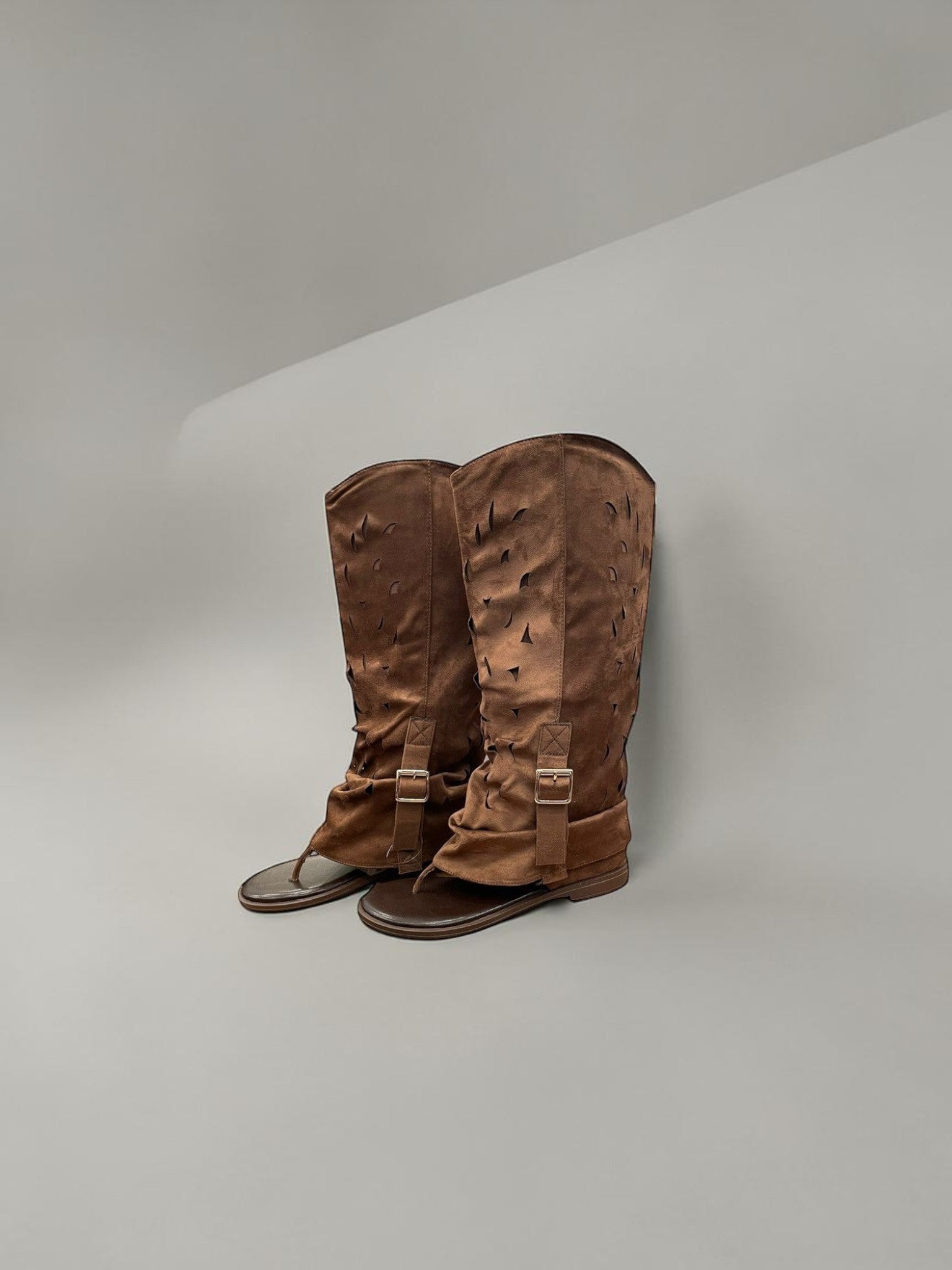 Day One Concept Store brown perforated leather tall boots with buckle detail and flat sole.