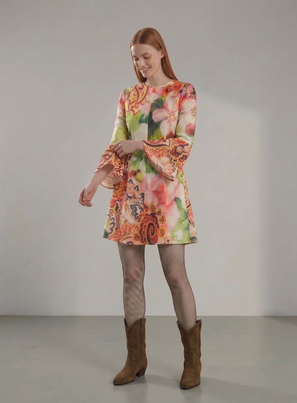 Day One Concept Store A-line mini dress with bell sleeves, vibrant floral and paisley print in pink, orange, green, and yellow.