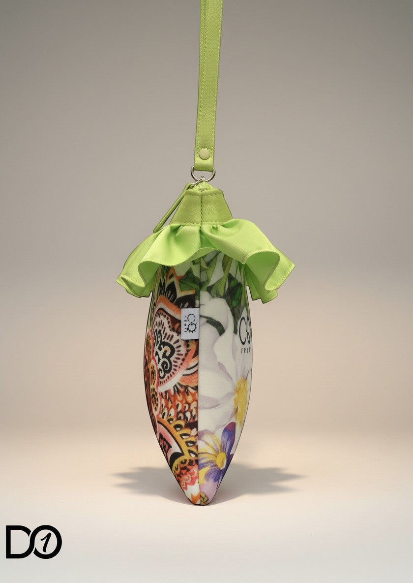 Day One Concept Store pochette with floral and paisley print, lime green frill detail, and wrist strap.
