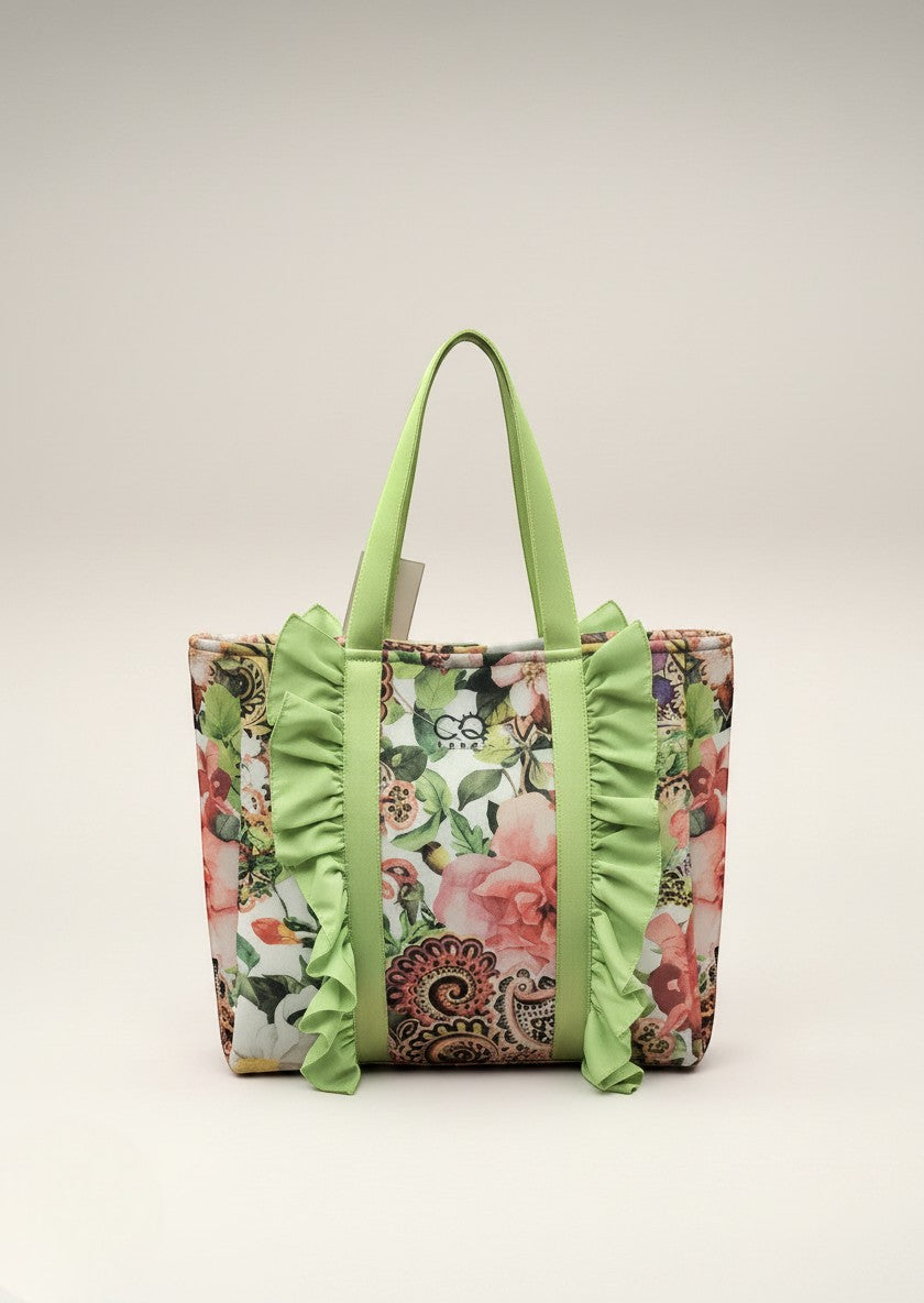 Day One Concept Store floral shopper bag with green ruffled handles and lime green straps. Features a vibrant floral print with pink roses and paisley details.