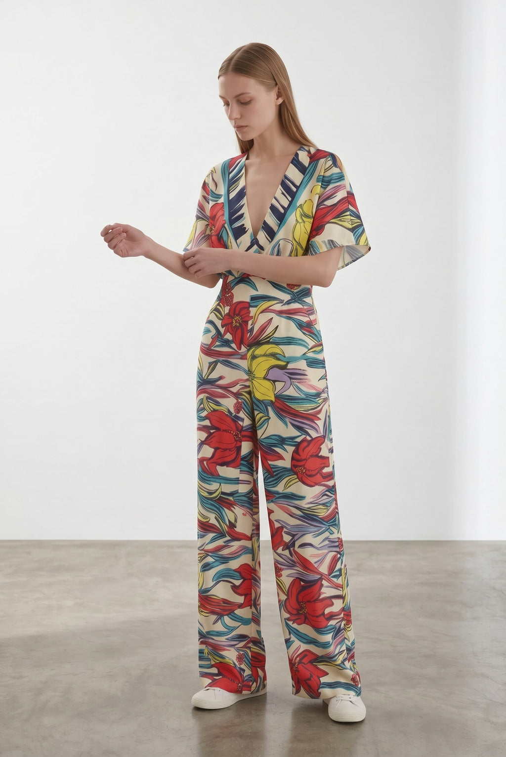 Day One Concept Store cream wide-leg jumpsuit with abstract floral print in red, yellow, and blue, V-neck, and kimono sleeves.