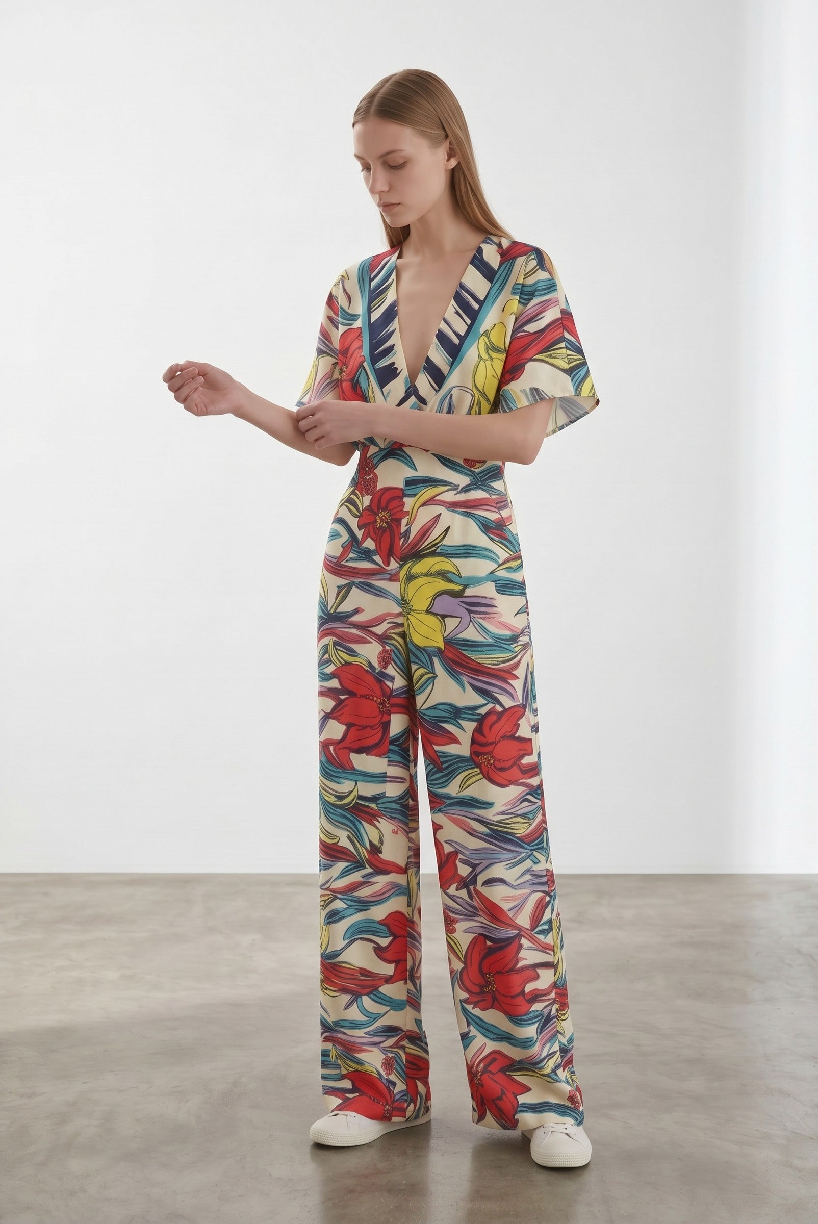 Day One Concept Store cream wide-leg jumpsuit with abstract floral print in red, yellow, and blue, V-neck, and kimono sleeves.
