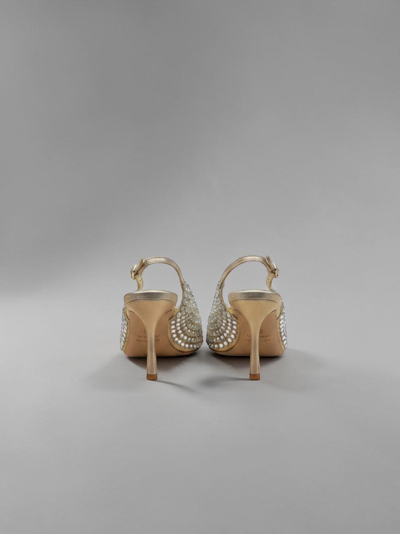 Day One Concept Store gold slingback heels adorned with rhinestones and pearls, featuring a pointed toe and stiletto heel.