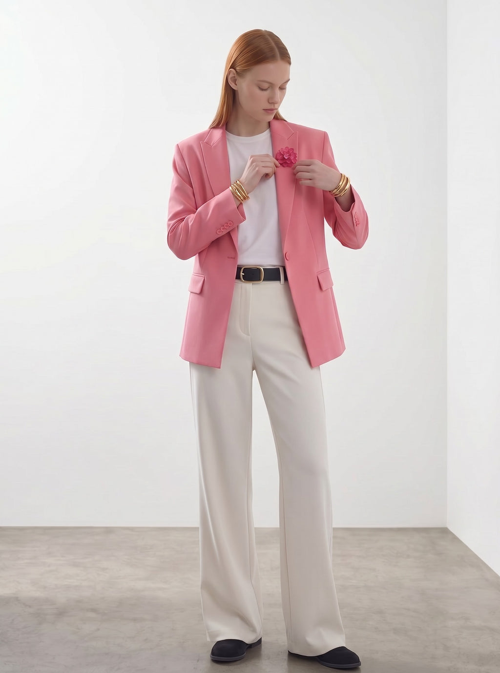 Day One Concept Store pink single-breasted blazer with single button closure and embellished pocket detail, worn by a model with a floral brooch.