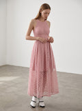 Day One Concept Store pink lace halter neck maxi dress with sheer overlay and fluid skirt. Model wears white heels and blue socks.