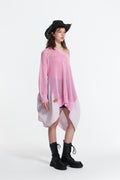 Day One Concept Store pink oversized knit sweater with asymmetric hem and striped fabric insert, worn off-shoulder.