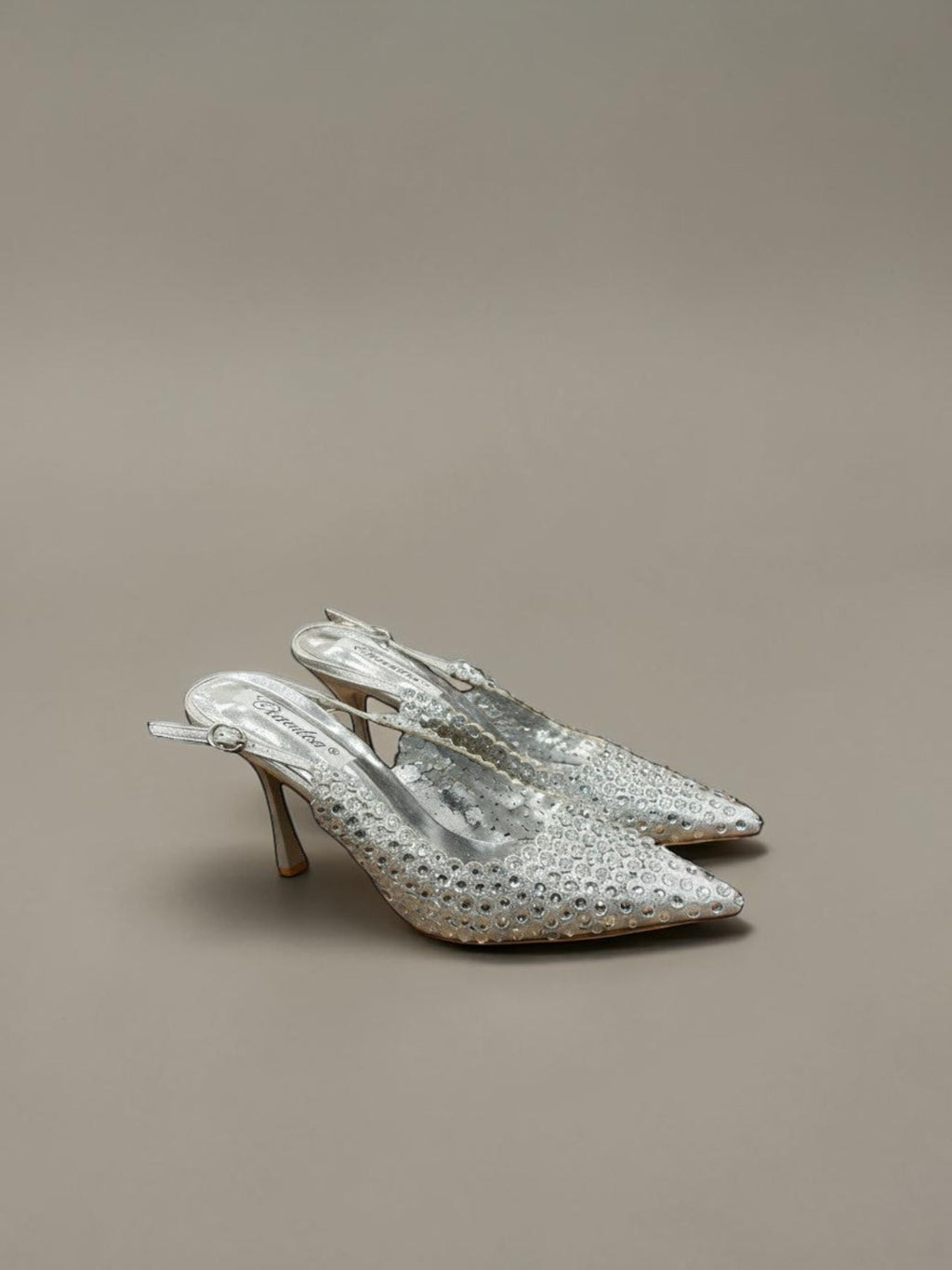 Day One Concept Store silver slingback heels with pointed toe, stiletto heel, and intricate rhinestone embellishments.