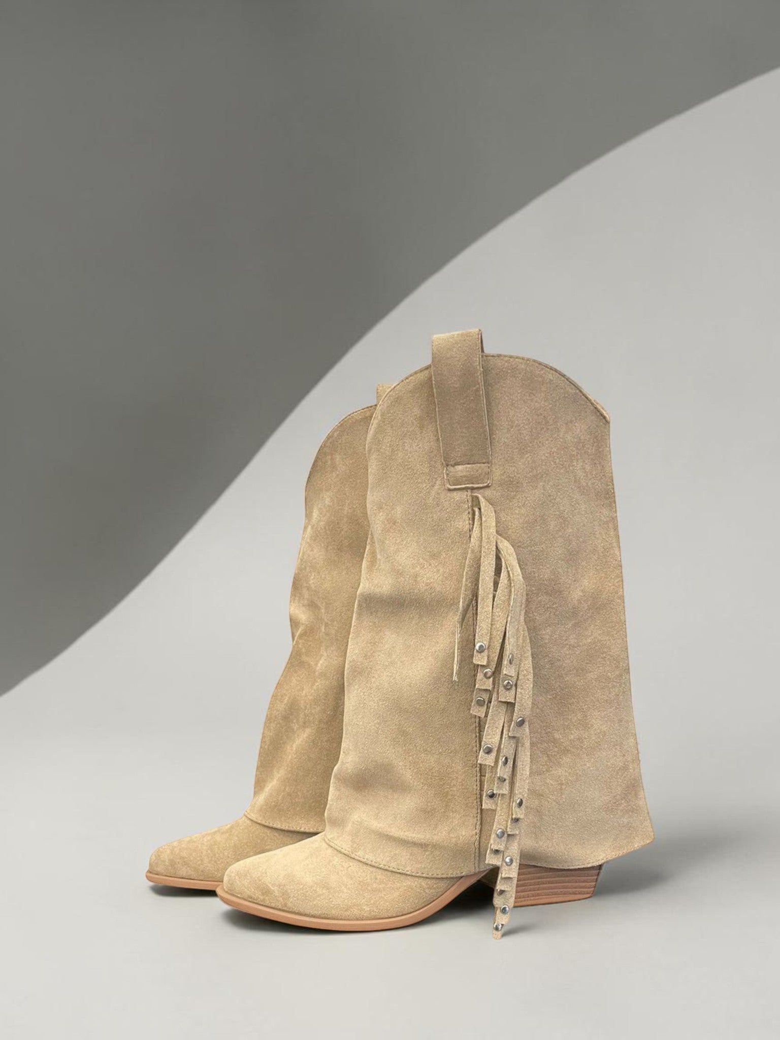 Day One Concept Store tan suede slouchy cowboy boots with fringe and stud accents.