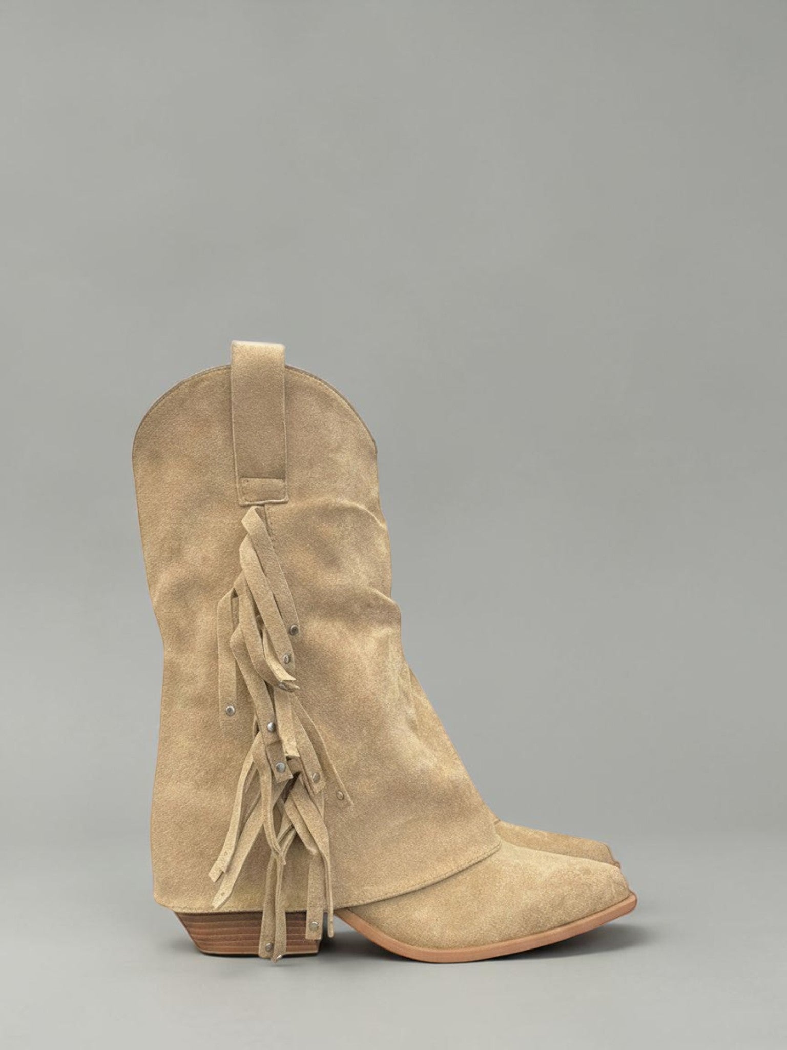 Day One Concept Store tan suede western boots with fringe detailing and subtle stud accents. Pointed toe with a low heel.