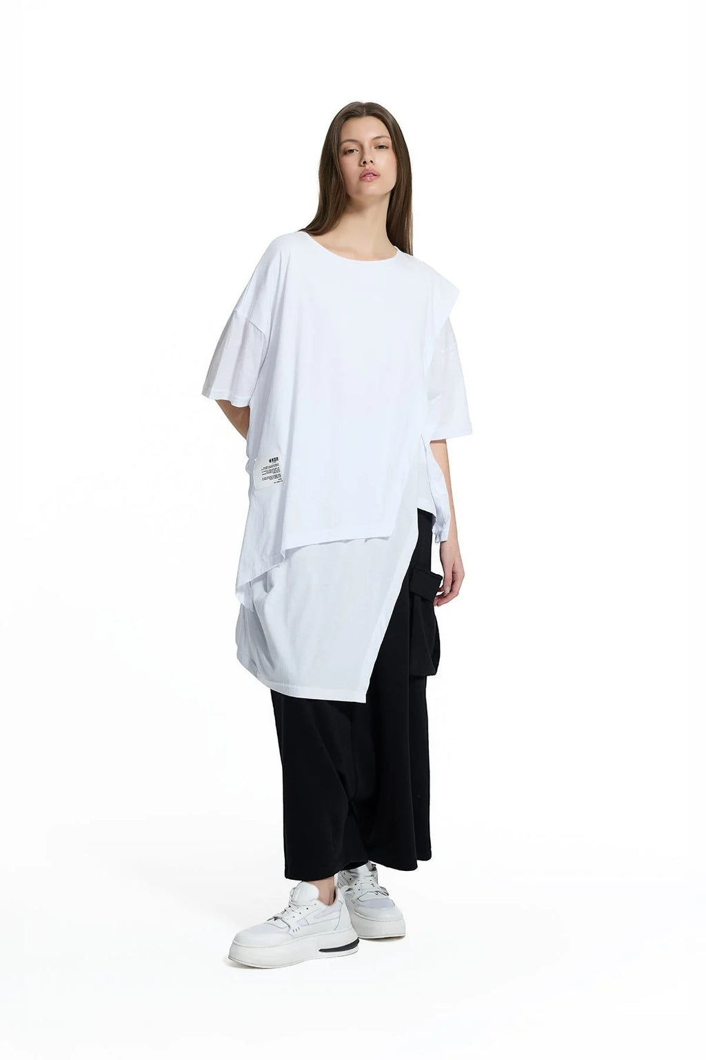 Day One Concept Store white oversized cotton t-shirt with layered asymmetrical hem and graphic detail on left side.