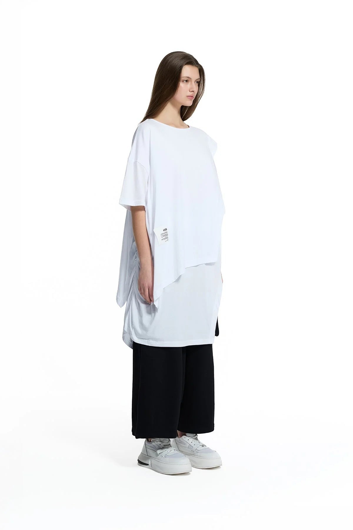 Day One Concept Store white oversized cotton t-shirt with asymmetric hem and ruched side detail, worn by a model.