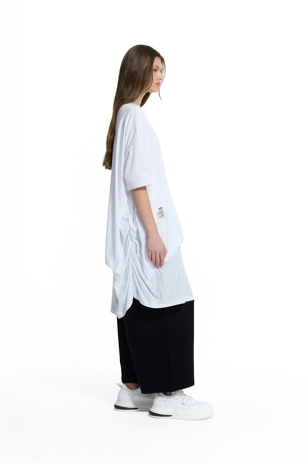 Day One Concept Store white oversized cotton t-shirt with ruched side detail and crew neck, worn by a model with long brown hair.